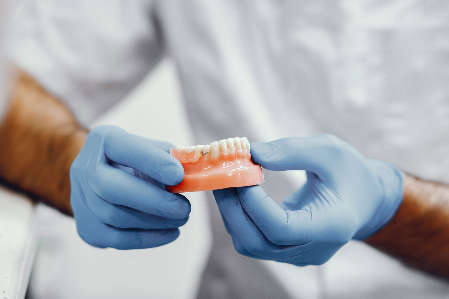 Dental restoration model held by a clinician